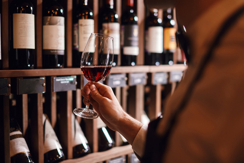 Bartender,Or,Male,Cavist,Standing,Near,The,Shelves,Of,Wine