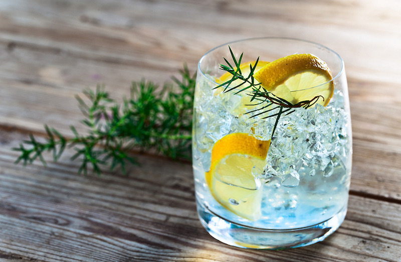 Gin,With,Lemon,And,Juniper,Branch,On,A,Old,Wooden