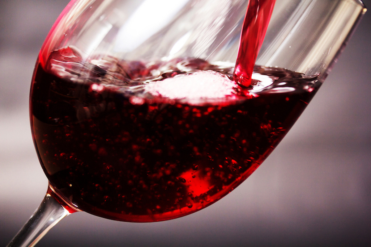 Glass,Of,Full,Bodied,Red,Wine,Being,Poured,From,Bottle