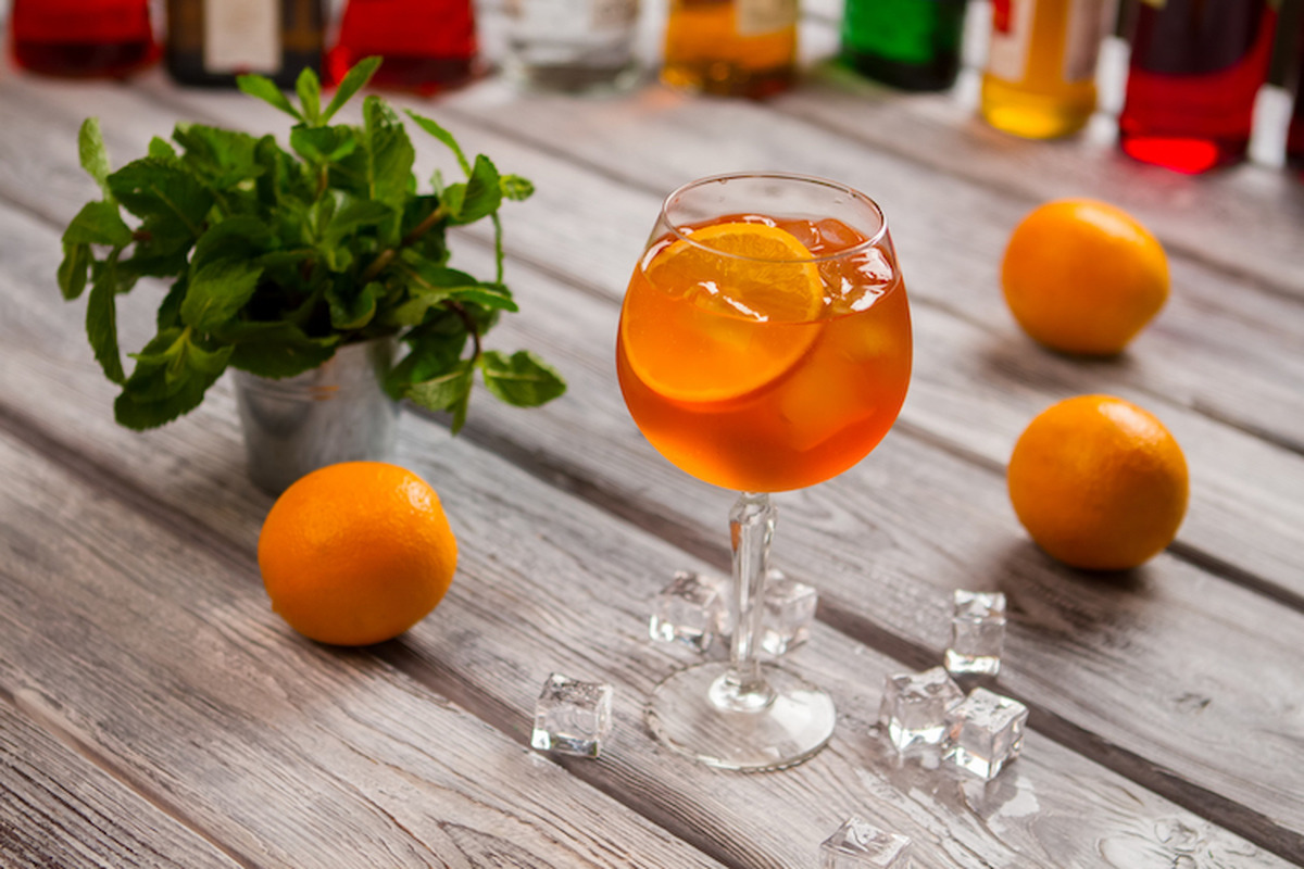 Wineglass with orange cocktail.