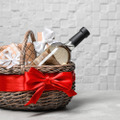 Gift,Basket,With,Bottle,Of,Wine,On,Light,Background.,Space