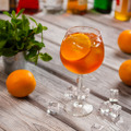 Wineglass with orange cocktail.