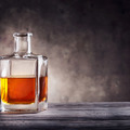 Square decanter of brandy on a dark background