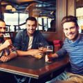 happy male friends drinking beer at bar or pub